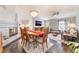 Open concept living room with fireplace, dining area, and modern chandelier at 8520 Copper Falls Ave, Las Vegas, NV 89129