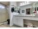 Well-lit bathroom features a granite countertop, generous mirror, shower, and a vanity area at 8808 Litchfield Ave, Las Vegas, NV 89134