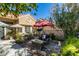 A cozy front courtyard featuring patio furniture, lush plantings, and a secure front entrance at 8808 Litchfield Ave, Las Vegas, NV 89134