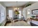 Cozy dining room with a rustic table, natural light, and decorative plants at 8808 Litchfield Ave, Las Vegas, NV 89134