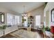 Charming dining area with a rustic table, decorative shelves, and bright windows at 8808 Litchfield Ave, Las Vegas, NV 89134