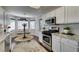 Bright kitchen featuring white cabinets, stainless steel appliances, granite countertops and breakfast nook at 8808 Litchfield Ave, Las Vegas, NV 89134