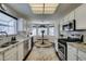 Bright kitchen featuring white cabinets, stainless steel appliances, granite countertops and breakfast nook at 8808 Litchfield Ave, Las Vegas, NV 89134