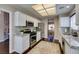 Bright kitchen with white cabinets, granite countertops, stainless steel appliances, and a view to the dining area at 8808 Litchfield Ave, Las Vegas, NV 89134