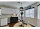 Bright breakfast nook with a modern light fixture, and a view into the kitchen with granite countertops and white cabinets at 8808 Litchfield Ave, Las Vegas, NV 89134