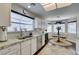 Bright kitchen featuring white cabinets, stainless steel appliances, granite countertops and a view of the breakfast nook at 8808 Litchfield Ave, Las Vegas, NV 89134