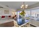 Open living area with dining table and living room with natural light and sliding door access at 8808 Litchfield Ave, Las Vegas, NV 89134