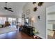 Living room showing hardwood floors, tv, and view into kitchen at 8808 Litchfield Ave, Las Vegas, NV 89134