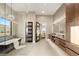 Bright bathroom featuring a soaking tub, dual vanities, and modern fixtures at 9 Stonecutter Ct, Henderson, NV 89012