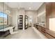 Bright bathroom featuring a soaking tub, dual vanities, and a glass-enclosed shower at 9 Stonecutter Ct, Henderson, NV 89012