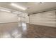 Spacious garage with ample room for multiple vehicles and storage, featuring a large roll-up door at 9 Stonecutter Ct, Henderson, NV 89012