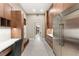 Modern kitchen with stainless steel refrigerator, lots of cabinet space, and built-in desk at 9 Stonecutter Ct, Henderson, NV 89012