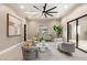 Bright living room featuring a large ceiling fan, modern furnishings, and sliding glass doors at 9 Stonecutter Ct, Henderson, NV 89012