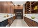 Spacious pantry features floor-to-ceiling cabinetry, countertop space, a wine fridge, and a sleek design at 9 Stonecutter Ct, Henderson, NV 89012