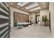 Cozy seating area with stone accent wall and multiple skylights at 9 Stonecutter Ct, Henderson, NV 89012