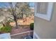 Backyard view with a mature tree and common area at 917 Collingtree St, Las Vegas, NV 89145