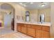 Bright bathroom with double vanity, wood cabinets, large mirror, and neutral decor at 917 Collingtree St, Las Vegas, NV 89145