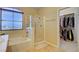 Bright bathroom featuring a tub, a glass enclosed shower, and a walk-in closet at 917 Collingtree St, Las Vegas, NV 89145