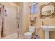 Bright bathroom featuring a pedestal sink and tiled walk-in shower at 917 Collingtree St, Las Vegas, NV 89145