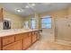 Bright bathroom with double sinks, tub, and glass-enclosed shower at 917 Collingtree St, Las Vegas, NV 89145