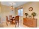 Elegant dining room with a chandelier, natural light, and stylish furniture at 917 Collingtree St, Las Vegas, NV 89145