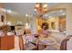 Open dining room showcasing a chandelier with adjacent living area and kitchen access at 917 Collingtree St, Las Vegas, NV 89145