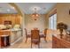 Cozy dining room connects to the kitchen, illuminated by a chandelier, perfect for gatherings at 917 Collingtree St, Las Vegas, NV 89145