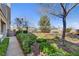 Exterior shot of the home from the common area, with benches, landscaping, and paths at 917 Collingtree St, Las Vegas, NV 89145