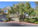 Traditional home with a two-car garage, mature trees and verdant landscaping at 917 Collingtree St, Las Vegas, NV 89145