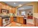 Well-lit kitchen features stainless steel appliances and wood flooring at 917 Collingtree St, Las Vegas, NV 89145