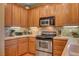 Galley kitchen featuring stainless steel appliances and tile backsplash at 917 Collingtree St, Las Vegas, NV 89145