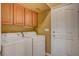 Functional laundry room equipped with a washer, dryer, and storage cabinets at 917 Collingtree St, Las Vegas, NV 89145