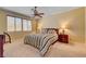 Bedroom featuring neutral carpet, ceiling fan, and large windows at 917 Collingtree St, Las Vegas, NV 89145