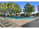 Inviting community pool area with lounge chairs and shade trees at 917 Collingtree St, Las Vegas, NV 89145