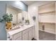 Modern bathroom vanity with decorative accents, leading to a walk-in closet at 9355 Jade Mesa St # 52, Las Vegas, NV 89139