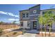 Modern townhouse exterior featuring a two-story design, neutral colors, and a landscaped front yard at 9355 Jade Mesa St # 52, Las Vegas, NV 89139