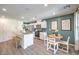 Bright kitchen featuring stainless appliances, white cabinetry, and an island with bar seating at 9355 Jade Mesa St # 52, Las Vegas, NV 89139