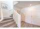 Staircase featuring carpeted steps, a white railing, and a neutral-colored hallway with interior doors at 9355 Jade Mesa St # 52, Las Vegas, NV 89139