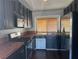 Compact kitchen featuring dark cabinetry, stainless steel appliances, and durable tile countertops at , Henderson, NV 89074