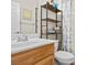 Bathroom with a vessel sink, shelving and a shower tub combo at 1009 Via Canale Dr, Henderson, NV 89011