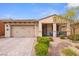 Charming single-story home with a two-car garage, desert landscaping and covered front porch at 1009 Via Canale Dr, Henderson, NV 89011