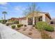 Inviting one-story home with a quaint front porch, desert landscaping, and two-car attached garage at 1009 Via Canale Dr, Henderson, NV 89011