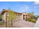 Single-story home with a two-car garage, a covered front porch and low-maintenance landscaping at 1009 Via Canale Dr, Henderson, NV 89011