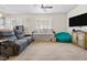 Comfortable living room featuring neutral colored walls, an area rug, and bright natural light at 1009 Via Canale Dr, Henderson, NV 89011