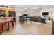Wide open living room area with a combined kitchen featuring a breakfast bar with bar stools at 1009 Via Canale Dr, Henderson, NV 89011
