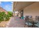 Covered patio with pavers, seating, and well-maintained landscaping at 1009 Via Canale Dr, Henderson, NV 89011
