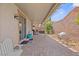 Covered patio with stone pavers, outdoor seating, and a landscaped yard at 1009 Via Canale Dr, Henderson, NV 89011