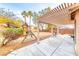 Large backyard featuring a playground and a shaded patio area for outdoor enjoyment at 10332 George Hart Ct, Las Vegas, NV 89129