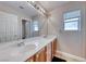 Bright bathroom featuring double sinks with ample countertop space and a large mirror at 10332 George Hart Ct, Las Vegas, NV 89129