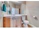 Compact powder room with a single vanity, toilet, and minimal decor for functionality at 10332 George Hart Ct, Las Vegas, NV 89129